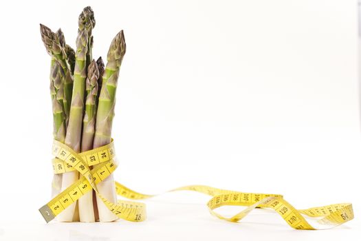 Asparagus and measuring type on a white background