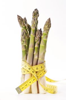 Asparagus and measuring type on a white background