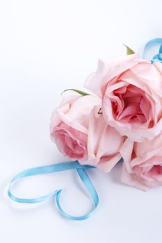 A bouquet of roses with ribbon in heart shape 