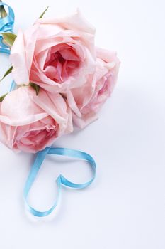 A bouquet of roses with ribbon in heart shape 