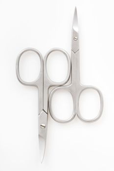Two pairs of scissors on a white background