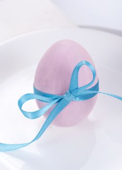 Easter table setting with plates, napkin and easter egg