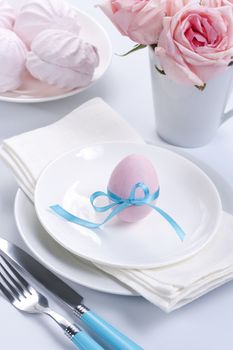 Easter table setting with flowers and easter egg