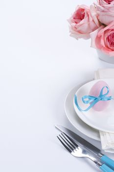 Easter table setting with flowers and easter egg