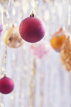 Christmas balls hanging on silver background