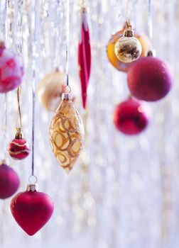 Christmas balls hanging on silver background