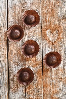 Chocolate candies on wooden background