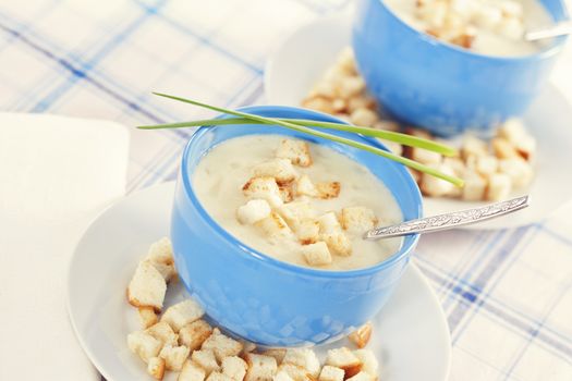 Vegetable cream soup in blue bowls