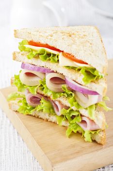 Club sandwich with ham and vegetables