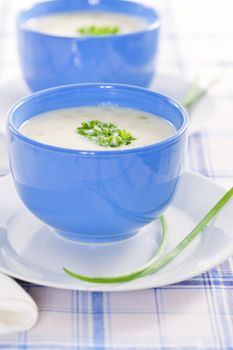 Vegetable cream soup in blue bowls