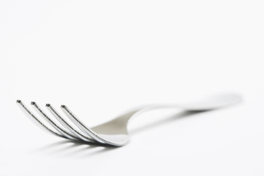 Stainless steel fork on white backround