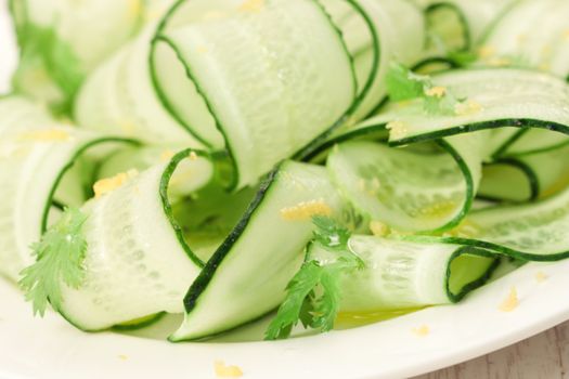 Sliced green cucumbers salad with cilantro