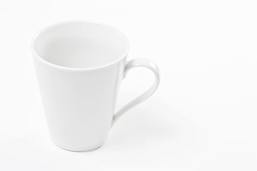 Empty white cup over white background