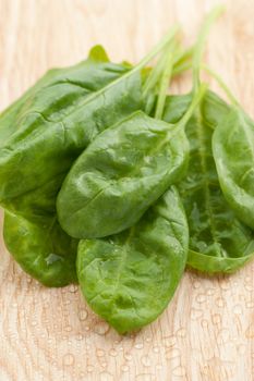 Fresh spinach on wooden background 