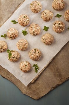 Meatballs cooking with mince, parsley, parmesan, wine and eggs.