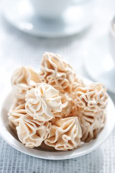 Meringues on white tablecloth, shallow dof.