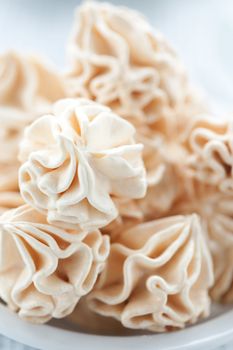 Meringues on white background, shallow dof.