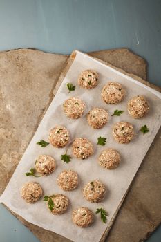 Meatballs cooking with mince, parsley, parmesan, wine and eggs.