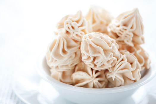 Meringues on white tablecloth, shallow dof.