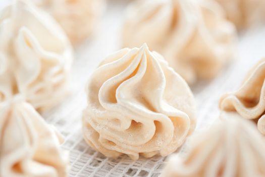 Meringues on white tablecloth, shallow dof.