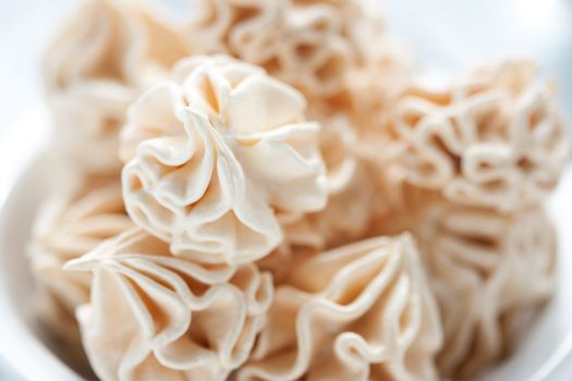 Meringues on white background, shallow dof.