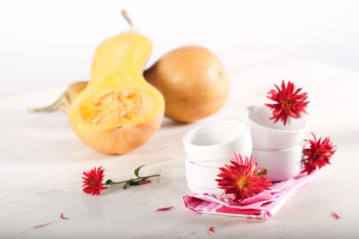 Pumpkins, cooking utensil and autumn flowers.