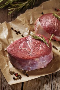 Raw beef steak on wooden table.