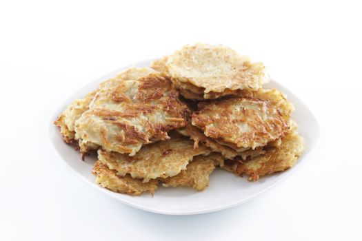 Heap of potato pancakes on plate 