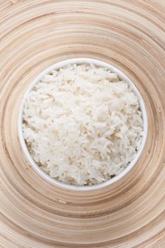 Rice in a bowl on a bamboo plate. Concept of the importance of rice