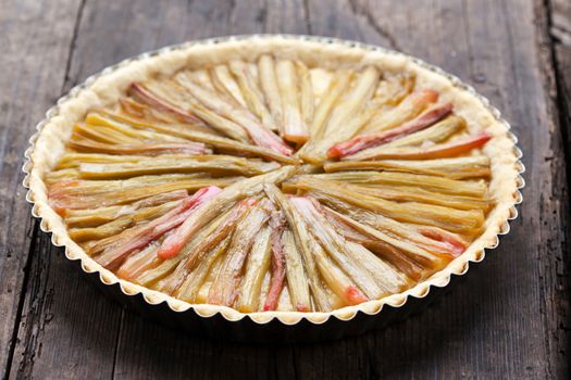 Delicious rhubarb pie on rustic background