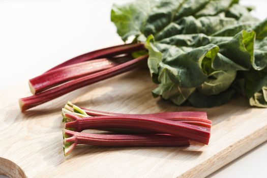 Fresh rhubarb on wooden background