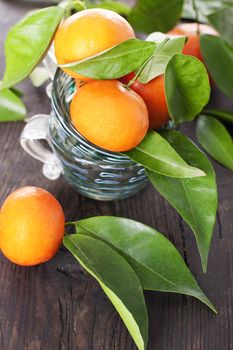 Ripe tangerines on a wooden table