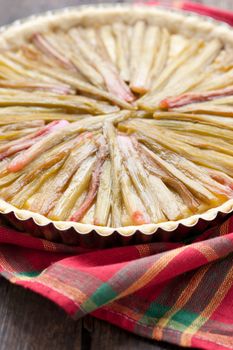 Delicious rhubarb pie on rustic background