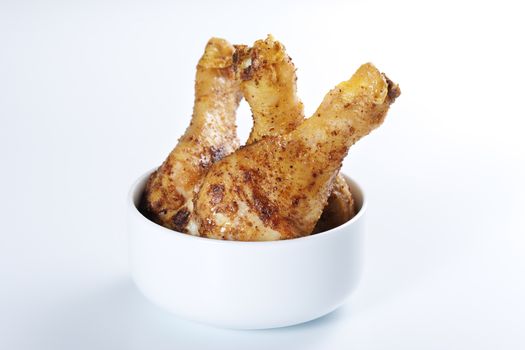Roasted chicken legs in a bowl