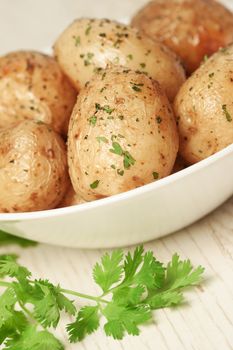 Roasted potatoes with parsley in bowl