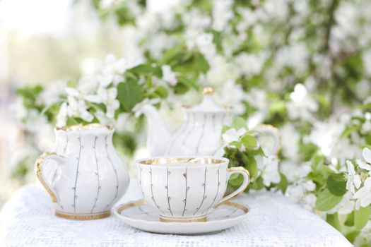 Romantic tea in the blossoming garden
