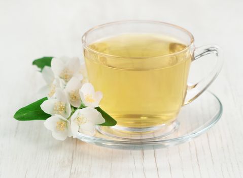 Green tea with fresh jasmine flowers. 