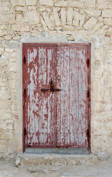 Weathered red door in traditional moroccon house