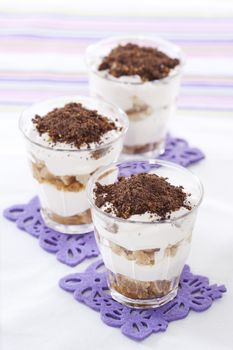 Tasty tiramisu dessert in glasses