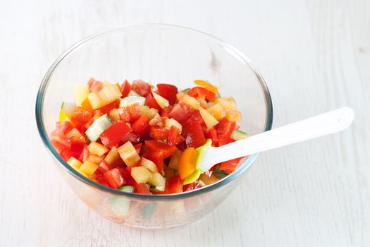 Cooking, mixing fresh vegetable salad