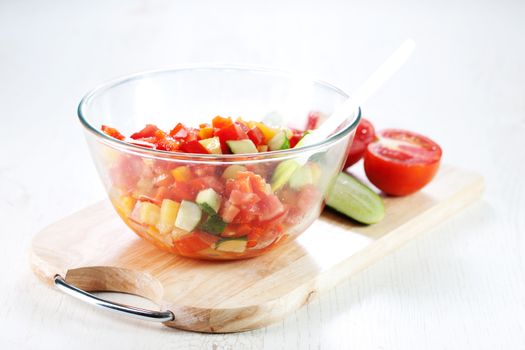 Cooking, mixing fresh vegetable salad