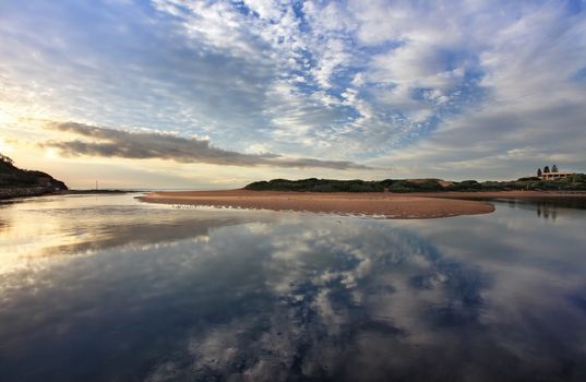 Capturing the cloud reflections in the water at Narrabeen Lakes entrance on the Northern beaches, Sydney.