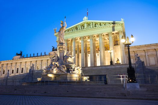 VIENNA, AUSTRIA - AUGUST 4, 2013: Austrian Parliament Building and The Athena Fountain at night.