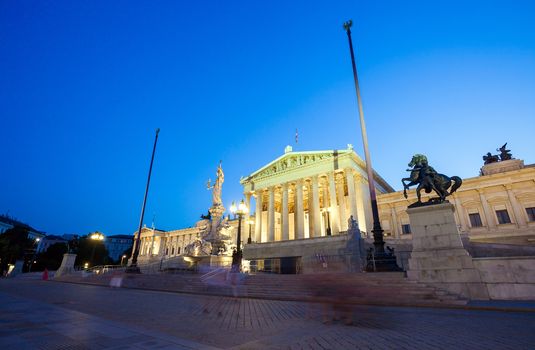 VIENNA, AUSTRIA - AUGUST 4, 2013: Austrian Parliament Building and The Athena Fountain at night.