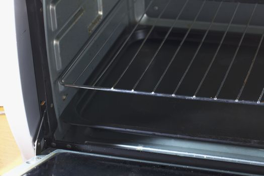 Open electric oven, empty, in a kitchen