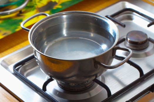 Pot full of water over cooking gas