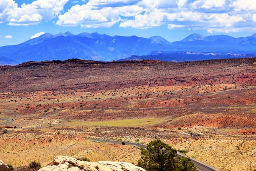 Painted Desert Colorful Yellow Grass Lands Orange Sandstone La Salle Mountains Arches National Park Moab Utah USA Southwest.