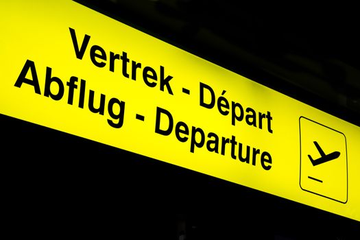 Airport departure board in terminal with flight information