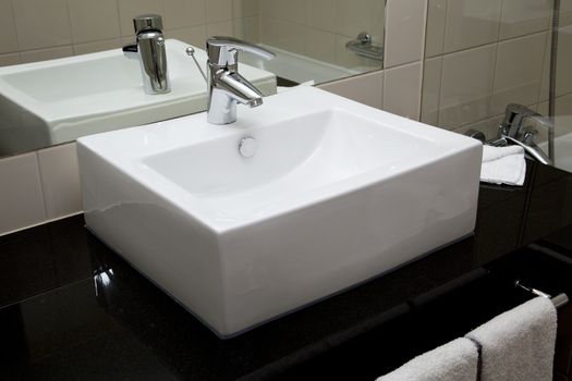 Water crane and white sink in a bathroom