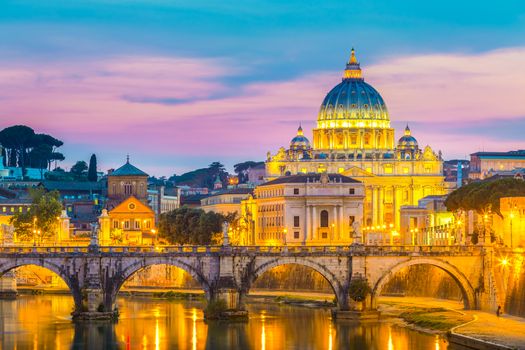 Night view of old roman Bridge of Hadrian and St. Peter's cathedral in Vatican City Rome Italy.